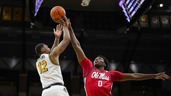 Jan 25, 2025; Columbia, Missouri, USA; Missouri Tigers guard Tony Perkins (12) shoots against Mississippi Rebels forward Malik Dia (0) during the first half at Mizzou Arena. Mandatory Credit: Jay Biggerstaff-Imagn Images Jan 25, 2025; Columbia, Missouri, USA; Missouri Tigers guard Tony Perkins (12) shoots against Mississippi Rebels forward Malik Dia (0) during the first half at Mizzou Arena. Mandatory Credit: Jay Biggerstaff-Imagn Images
