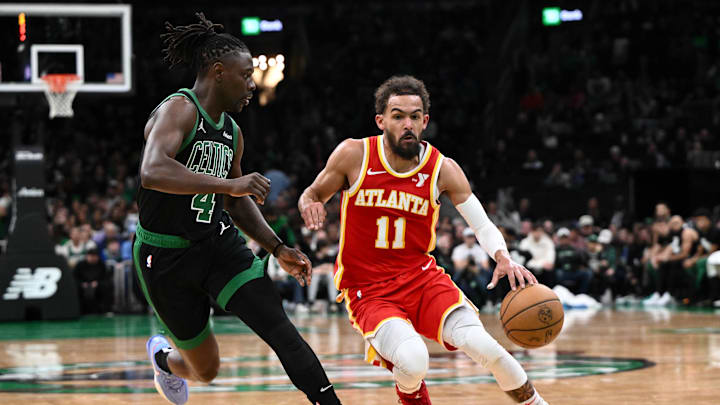 Jan 18, 2025; Boston, Massachusetts, USA; Atlanta Hawks guard Trae Young (11) drives to the basket against Boston Celtics guard Jrue Holiday (4) during the second quarter at the TD Garden. Mandatory Credit: Brian Fluharty-Imagn Images