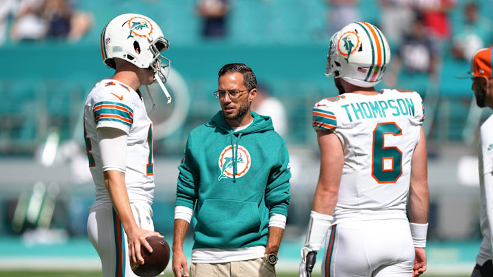 Miami Dolphins head coach Mike McDaniel talks with quarterback Mike White (14) and quarterback
