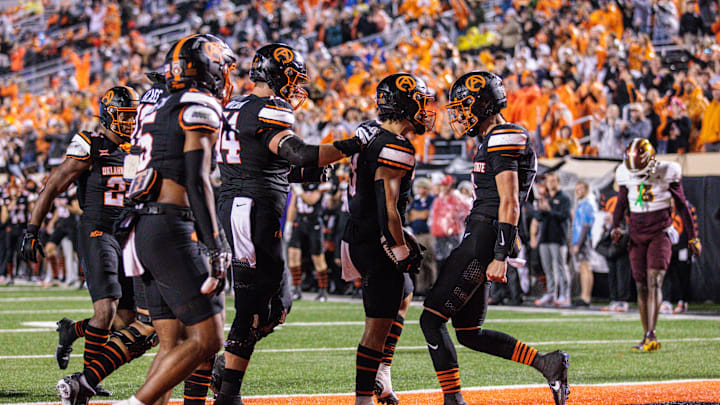 Nov 2, 2024; Stillwater, Oklahoma, USA; Oklahoma State Cowboys quarterback Maealiuaki Smith (8) celebrates in the end zone after a touchdown during the fourth quarter against the Arizona State Sun Devils at Boone Pickens Stadium. Mandatory Credit: William Purnell-Imagn Images