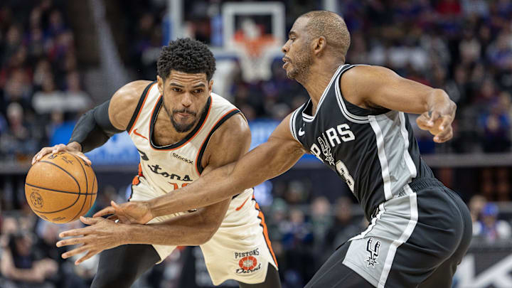 Mar 25, 2025; Detroit, Michigan, USA; San Antonio Spurs guard Chris Paul (3) defends against Detroit Pistons forward Tobias Harris (12) during the first half at Little Caesars Arena. Mandatory Credit: David Reginek-Imagn Images