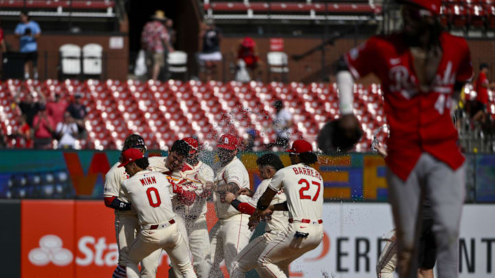 Jun 21, 2025; St. Louis, Missouri, USA;  St. Louis Cardinals catcher Yohel Pozo (63) is mobbed by teammates after hitting a walk-off one run single against the Cincinnati Reds during the eleventh inning at Busch Stadium. Mandatory Credit: Jeff Curry-Imagn Images
