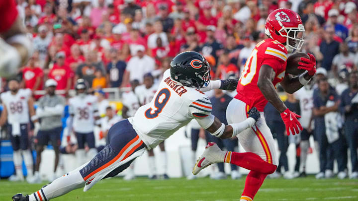 Aug 22, 2025; Kansas City, Missouri, USA; Kansas City Chiefs running back Brashard Smith (30) catches a pass as Chicago Bears safety Jaquan Brisker (9) makes the tackle during the first half of the game at GEHA Field at Arrowhead Stadium. Mandatory Credit: Denny Medley-Imagn Images