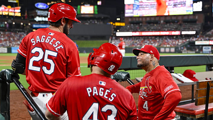 Aug 8, 2025; St. Louis, Missouri, USA;  St. Louis Caridnals guest coach Yadier Molina (4) talks with third baseman Thomas Saggese (25) and catcher Pedro Pages (43) during the eighth inning against the Chicago Cubs at Busch Stadium. Mandatory Credit: Jeff Curry-Imagn Images
