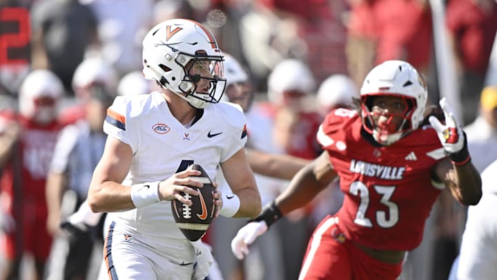 Oct 4, 2025; Louisville, Kentucky, USA; Virginia Cavaliers quarterback Chandler Morris (4) looks to pass against Louisville Cardinals defensive lineman Wesley Bailey (23) during the first quarter at L&N Federal Credit Union Stadium. Mandatory Credit: Jamie Rhodes-Imagn Images