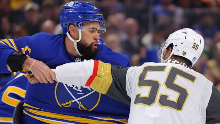 Mar 15, 2025; Buffalo, New York, USA;  Buffalo Sabres left wing Jordan Greenway (12) and Vegas Golden Knights right wing Keegan Kolesar (55) fight during the second period at KeyBank Center. Mandatory Credit: Timothy T. Ludwig-Imagn Images
