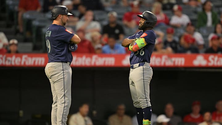 Jul 24, 2025; Anaheim, California, USA;  Seattle Mariners left fielder Randy Arozarena (56) is congratulated by catcher Cal Raleigh (29) after hitting a two run home run in the fifth inning against the Los Angeles Angels at Angel Stadium. Mandatory Credit: Jayne Kamin-Oncea-Imagn Images
