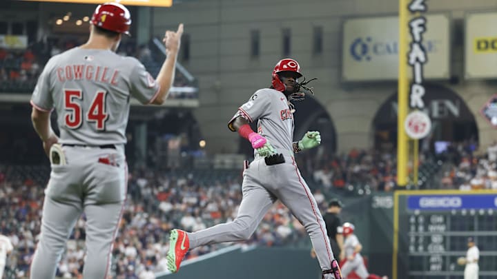 May 10, 2025; Houston, Texas, USA; Cincinnati Reds first base coach Collin Cowgill (54) signals and shortstop Elly De La Cruz (44) rounds the bases after hitting a home run during the first inning against the Houston Astros at Daikin Park. Mandatory Credit: Troy Taormina-Imagn Images