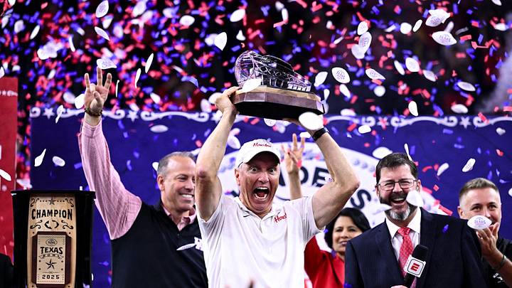 Dec 27, 2025; Houston, TX, USA; Houston Cougars head coach Willie Fritz hoists the champions trophy after the win over Louisiana State Tigers at NRG Stadium. Mandatory Credit: Maria Lysaker-Imagn Images