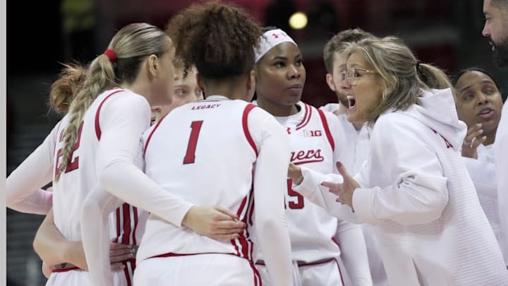 Wisconsin head coach Robin Pingeton talks to her team during overtime.