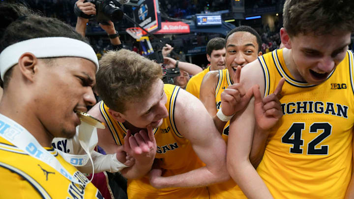Michigan Wolverines players react after they defeat the Wisconsin Badgers during the 2025 TIAA Big Ten Men’s Basketball Tournament final game on Sunday, March 16, 2025, at Gainbridge Fieldhouse in Indianapolis. Michigan defeated Wisconsin 59-53.