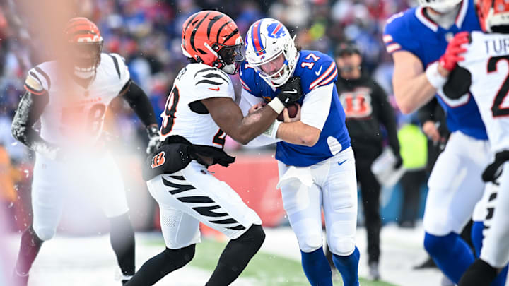 Dec 7, 2025; Orchard Park, New York, USA; Buffalo Bills quarterback Josh Allen (17) is tackled by Cincinnati Bengals linebacker Barrett Carter (49) in the third quarter at Highmark Stadium. Mandatory Credit: Mark Konezny-Imagn Images