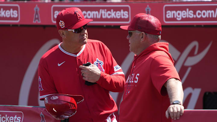 Mar 18, 2023; Tempe, Arizona, USA; Los Angeles Angels third base coach Bill Haselman (82) and manager Phil Nevin (88) talk before a game against the Texas Rangers at Tempe Diablo Stadium. Mandatory Credit: Rick Scuteri-Imagn Images Mar 18, 2023; Tempe, Arizona, USA; Los Angeles Angels third base coach Bill Haselman (82) and manager Phil Nevin (88) talk before a game against the Texas Rangers at Tempe Diablo Stadium. Mandatory Credit: Rick Scuteri-Imagn Images