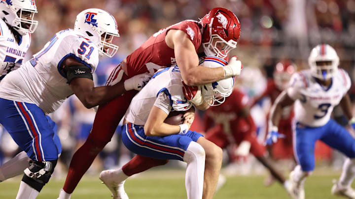 Nov 23, 2024; Fayetteville, Arkansas, USA; Arkansas Razorbacks defensive lineman Landon Jackson (40) sacks Louisiana Tech Bulldogs quarterback Evan Bullock (7) during the fourth quarter