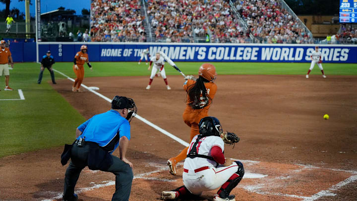 Texas infielder Victoria Hunter hits an infield grounder at the Women's College World Series.