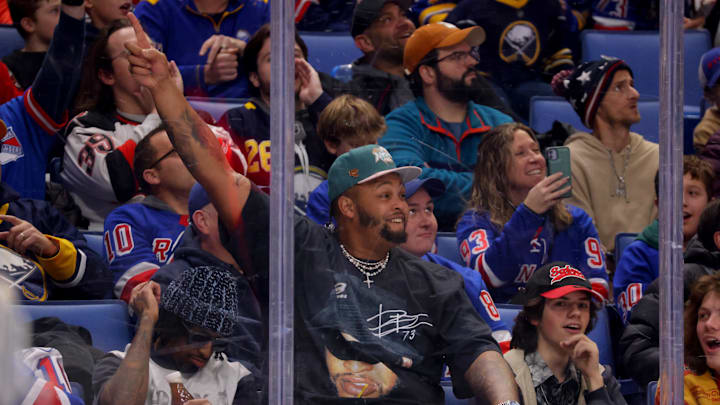Dec 11, 2024; Buffalo, New York, USA;  Buffalo Bills player Dion Dawkins cheers on the Buffalo Sabres against the New York Rangers during the second period at KeyBank Center.