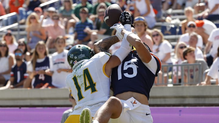 Sep 13, 2025; Charlottesville, Virginia, USA; William & Mary Tribe defensive back Ethan Yip (14) breaks up a touchdown pass for Virginia Cavaliers wide receiver Dillon Newton-Short (15) during the second half at Scott Stadium. Mandatory Credit: Amber Searls-Imagn Images Sep 13, 2025; Charlottesville, Virginia, USA; William & Mary Tribe defensive back Ethan Yip (14) breaks up a touchdown pass for Virginia Cavaliers wide receiver Dillon Newton-Short (15) during the second half at Scott Stadium. Mandatory Credit: Amber Searls-Imagn Images