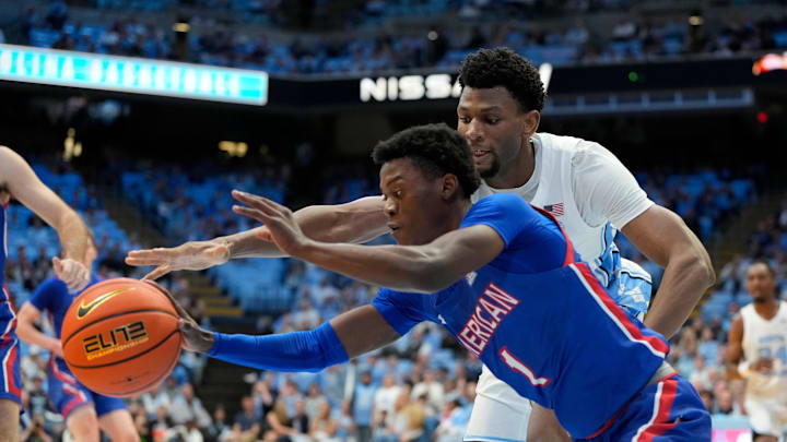 Nov 15, 2024; Chapel Hill, North Carolina, USA; American University Eagles guard Elijah Stephens (1) and North Carolina Tar Heels forward Jalen Washington (13) reach for the ball in the second half at Dean E. Smith Center. Mandatory Credit: Bob Donnan-Imagn Images