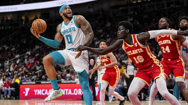 Apr 10, 2024; Atlanta, Georgia, USA; Charlotte Hornets forward Miles Bridges (0) tries to shoot over Atlanta Hawks forward Mouhamed Gueye (18) during the second half at State Farm Arena. Mandatory Credit: Dale Zanine-Imagn Images Apr 10, 2024; Atlanta, Georgia, USA; Charlotte Hornets forward Miles Bridges (0) tries to shoot over Atlanta Hawks forward Mouhamed Gueye (18) during the second half at State Farm Arena. Mandatory Credit: Dale Zanine-Imagn Images
