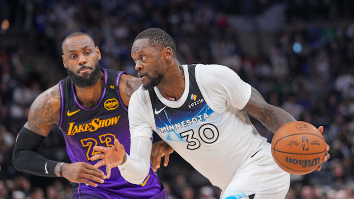 Dec 2, 2024; Minneapolis, Minnesota, USA; Minnesota Timberwolves forward Julius Randle (30) dribbles against the Los Angeles Lakers forward LeBron James (23) in the third quarter at Target Center. Mandatory Credit: Brad Rempel-Imagn Images