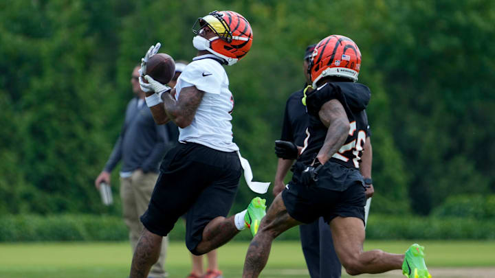 Cincinnati Bengals wide receiver Ja'Marr Chase (1) catches a deep pass ahead of cornerback DJ Turner II (20) during a session of organized team activities on the Bengals practice field at Paycor Stadium in downtown Cincinnati on Tuesday, June 3, 2025. Cincinnati Bengals wide receiver Ja'Marr Chase (1) catches a deep pass ahead of cornerback DJ Turner II (20) during a session of organized team activities on the Bengals practice field at Paycor Stadium in downtown Cincinnati on Tuesday, June 3, 2025.