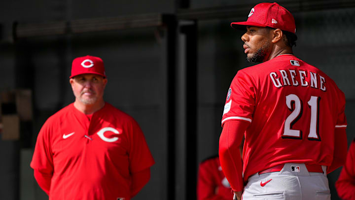 Cincinnati Reds pitcher Hunter Greene (21) throws a bullpen session as pitching coach/director of pitching Derek Johnson (36) watches at the Cincinnati Reds Player Development Complex in Goodyear, Ariz., on Thursday, Feb. 13, 2025.