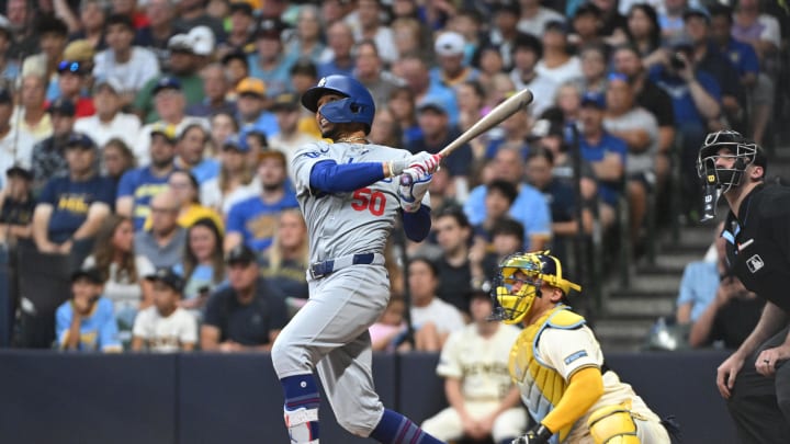 Aug 12, 2024; Milwaukee, Wisconsin, USA; Los Angeles Dodgers right field Mookie Betts (50) watches his home run go out over the wall against the Milwaukee Brewers at American Family Field. Mandatory Credit: Michael McLoone-USA TODAY Sports