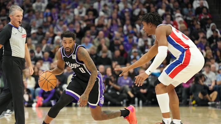 Dec 26, 2024; Sacramento, California, USA; Sacramento Kings guard Malik Monk (0) controls the ball against Detroit Pistons guard Jaden Ivey (23) during the fourth quarter at Golden 1 Center. Mandatory Credit: Kelley L Cox-Imagn Images Dec 26, 2024; Sacramento, California, USA; Sacramento Kings guard Malik Monk (0) controls the ball against Detroit Pistons guard Jaden Ivey (23) during the fourth quarter at Golden 1 Center. Mandatory Credit: Kelley L Cox-Imagn Images