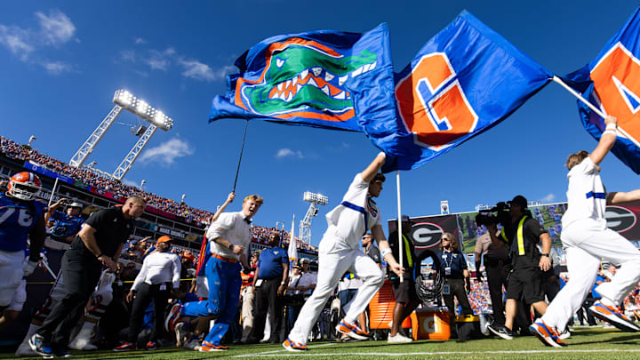 Florida Gators head coach Billy Napier runs out of the tunnel at the start of the Florida Georgia