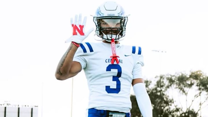 Tory Pittman III sporting Nebraska gloves while in his high school football gear.