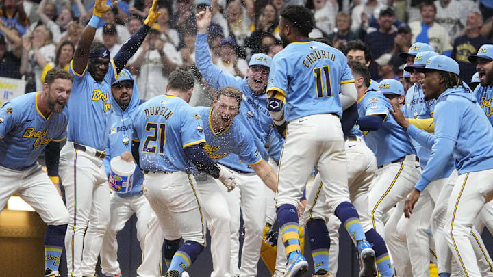 Jun 7, 2025; Milwaukee, Wisconsin, USA; Milwaukee Brewers players celebrate as Milwaukee Brewers third base Caleb Durbin (21) walk off home run against the San Diego Padres in the ninth inning at American Family Field. Mandatory Credit: Michael McLoone-Imagn Images
