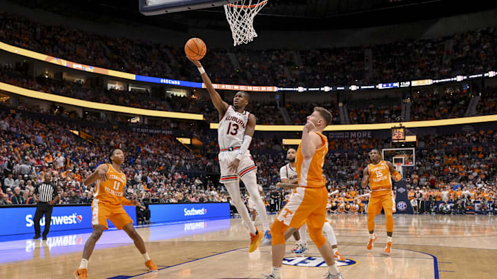 Mar 15, 2025; Nashville, TN, USA;  Auburn Tigers guard Miles Kelly (13) lays the ball in against the Tennessee Volunteers during the second half at Bridgestone Arena. Mandatory Credit: Steve Roberts-Imagn Images