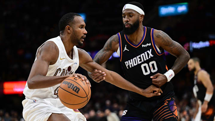 Cleveland Cavaliers center Evan Mobley drives on Phoenix Suns forward Royce O'Neale.