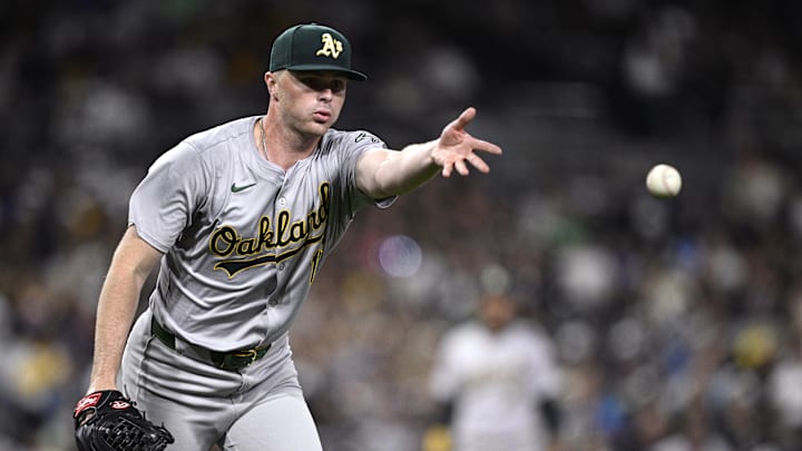 Jun 10, 2024; San Diego, California, USA; Oakland Athletics relief pitcher Sean Newcomb (16) tosses the ball to first base during the sixth inning against the San Diego Padres at Petco Park. Mandatory Credit: Orlando Ramirez-Imagn Images