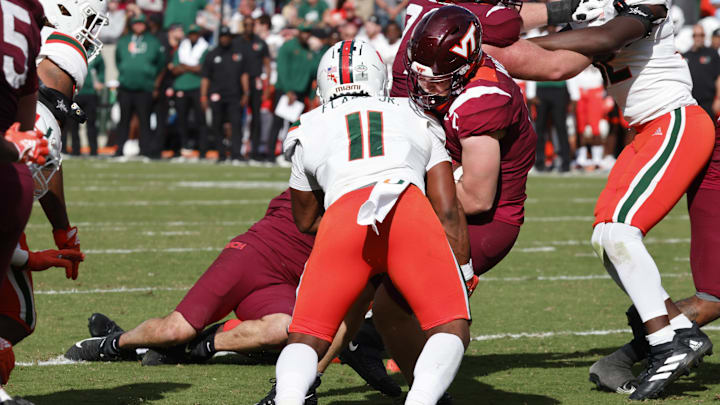 Oct 15, 2022; Blacksburg, Virginia, USA;  Virginia Tech Hokies quarterback Grant Wells (6) runs for a touchdown past Miami Hurricanes linebacker Corey Flagg Jr. (11) during the second half at Lane Stadium. Mandatory Credit: Reinhold Matay-Imagn Images