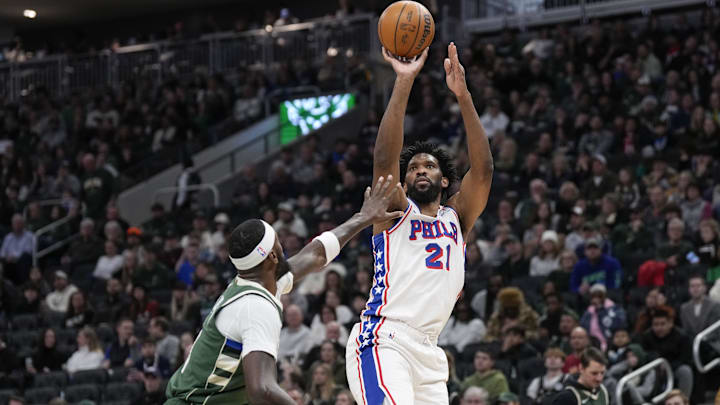 Feb 9, 2025; Milwaukee, Wisconsin, USA;  Philadelphia 76ers center Joel Embiid (21) shoots over Milwaukee Bucks forward Bobby Portis (9) during the second quarter at Fiserv Forum. Mandatory Credit: Jeff Hanisch-Imagn Images
