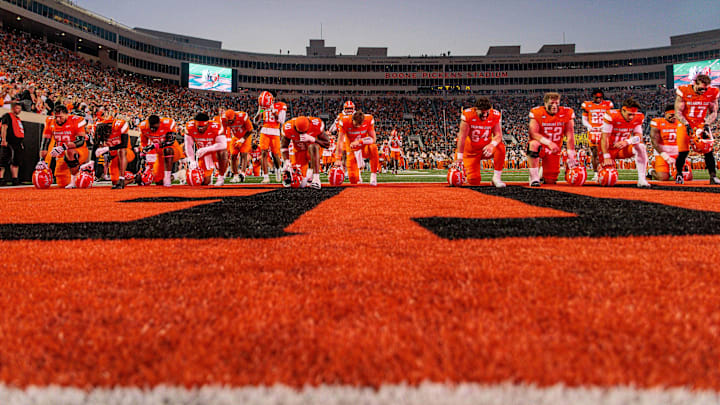 Oct 18, 2025; Stillwater, Oklahoma, USA; Oklahoma State Cowboys pray prior to the game against the Cincinnati Bearcats at Boone Pickens Stadium. Mandatory Credit: William Purnell-Imagn Images