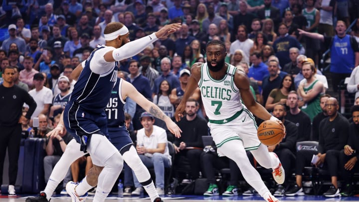 Jun 14, 2024; Dallas, Texas, USA; Boston Celtics guard Jaylen Brown (7) dribbles the ball against Dallas Mavericks center Daniel Gafford (21) during the first quarter during game four of the 2024 NBA Finals at American Airlines Center. Mandatory Credit: Peter Casey-USA TODAY Sports