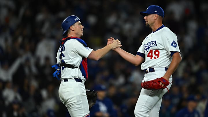Mar 29, 2025; Los Angeles, California, USA; Los Angeles Dodgers pitcher Blake Treinen (49) celebrates with catcher Will Smith (16) after defeating the Detroit Tigers at Dodger Stadium. Mandatory Credit: Jonathan Hui-Imagn Images