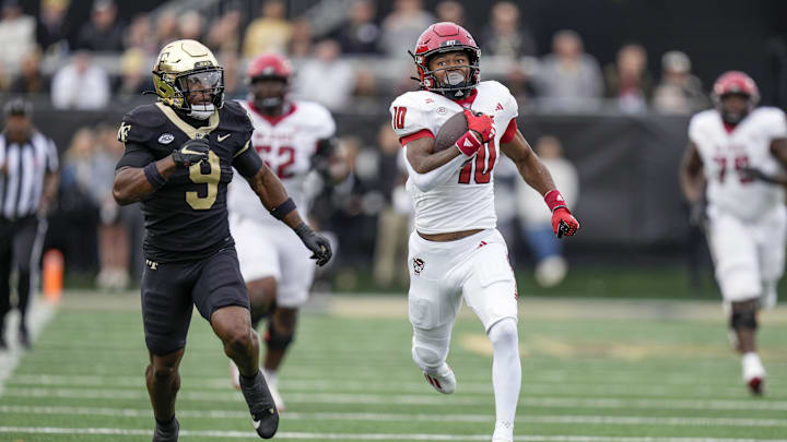Nov 11, 2023; Winston-Salem, North Carolina, USA; North Carolina State Wolfpack wide receiver Kevin Concepcion (10) runs down field after the catch chased by Wake Forest Demon Deacons defensive back Chelen Garnes (9) during the first half at Allegacy Federal Credit Union Stadium. Mandatory Credit: Jim Dedmon-Imagn Images