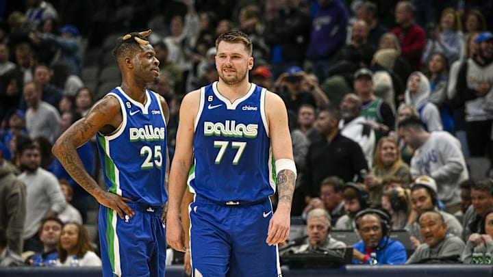 Jan 30, 2023; Dallas, Texas, USA; Dallas Mavericks forward Reggie Bullock (25) and guard Luka Doncic (77) walk back on to the court during the fourth quarter against the Detroit Pistons at the American Airlines Center. Mandatory Credit: Jerome Miron-Imagn Images