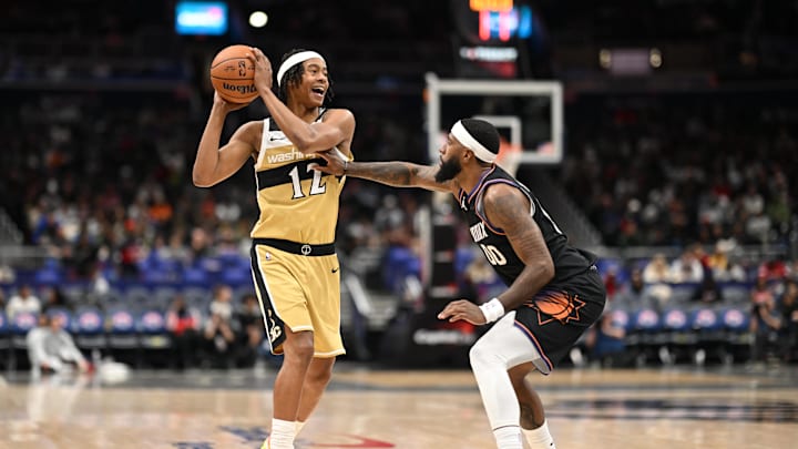 Dec 29, 2025; Washington, District of Columbia, USA; Washington Wizards guard Tre Johnson (12) looks to pass the ball in front of Phoenix Suns forward Royce O'Neale (00) during the third quarter at Capital One Arena. Mandatory Credit: Rafael Suanes-Imagn Images Dec 29, 2025; Washington, District of Columbia, USA; Washington Wizards guard Tre Johnson (12) looks to pass the ball in front of Phoenix Suns forward Royce O'Neale (00) during the third quarter at Capital One Arena. Mandatory Credit: Rafael Suanes-Imagn Images