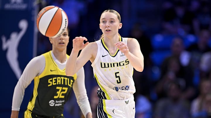 May 19, 2025; Arlington, Texas, USA;  Dallas Wings guard Paige Bueckers (5) receives a pass as Seattle Storm forward Alysha Clark (32) looks on during the second half at College Park Center. Mandatory Credit: Jerome Miron-Imagn Images