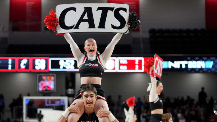 The Cincinnati Bearcats cheerleaders perform in the second half of a college basketball game between the Bradley Braves and the Cincinnati Bearcats during a second-round game of the National Invitation Tournament,, Saturday, March 23, 2024, at Fifth Third Arena in Cincinnati.