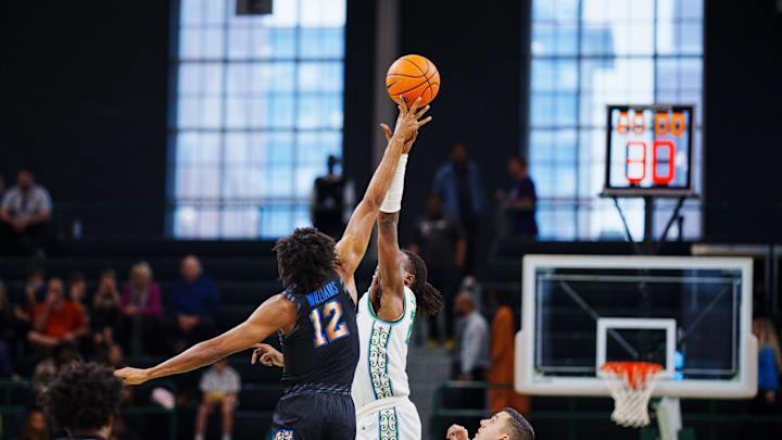 Jan 1, 2023; New Orleans, Louisiana, USA; Memphis Tigers forward DeAndre Williams (12) fights for the tipoff against Tulane Green Wave forward Percy Daniels (11) during the first half at Avron B. Fogelman Arena in Devlin Fieldhouse. Mandatory Credit: Andrew Wevers-Imagn Images Jan 1, 2023; New Orleans, Louisiana, USA; Memphis Tigers forward DeAndre Williams (12) fights for the tipoff against Tulane Green Wave forward Percy Daniels (11) during the first half at Avron B. Fogelman Arena in Devlin Fieldhouse. Mandatory Credit: Andrew Wevers-Imagn Images