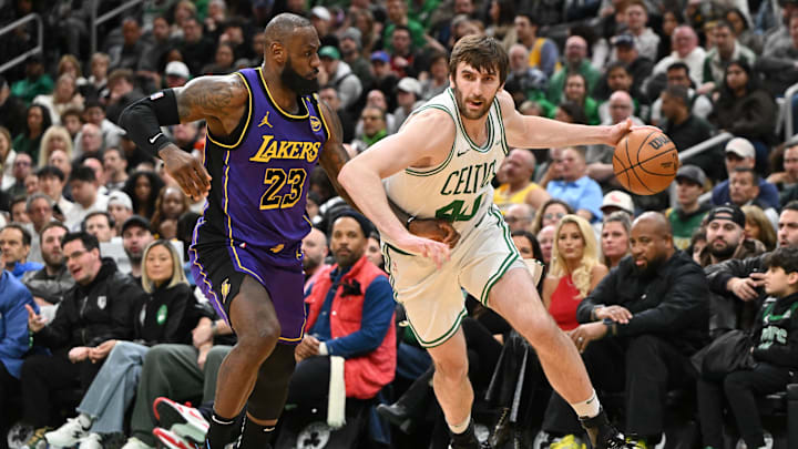 Mar 8, 2025; Boston, Massachusetts, USA; Boston Celtics center Luke Kornet (40) drives to the basket against Los Angeles Lakers forward LeBron James (23) during the fourth quarter at the TD Garden. Mandatory Credit: Brian Fluharty-Imagn Images