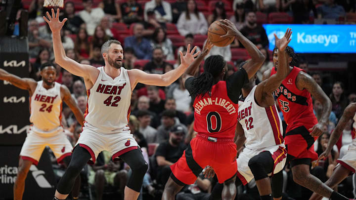 Toronto Raptors guard Javon Freeman-Liberty (0) looks to pass the ball as Miami Heat forward Kevin Love (42) and forward Jimmy Butler (22) defend during the first half at Kaseya Center. Mandatory Credit: Jim Rassol-Imagn Images