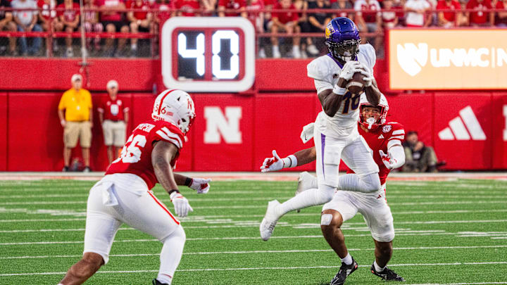 Sep 14, 2024; Lincoln, Nebraska, USA; Northern Iowa Panthers wide receiver Desmond Hutson (18) catches a pass against Nebraska Cornhuskers defensive back DeShon Singleton (8) and linebacker Stefon Thompson (56) during the second quarter at Memorial Stadium. Mandatory Credit: Dylan Widger-Imagn Images