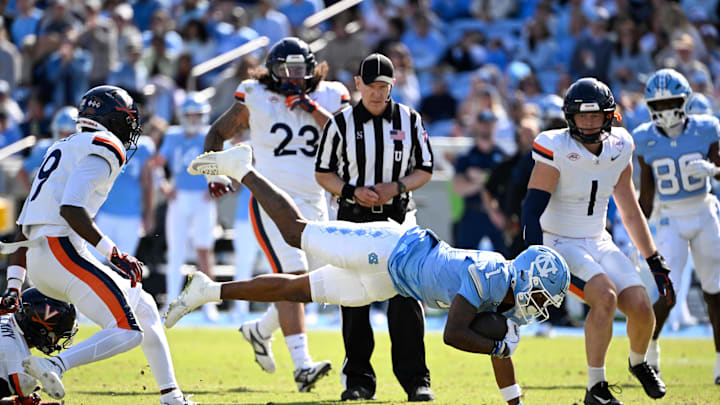 Oct 25, 2025; Chapel Hill, North Carolina, USA; North Carolina Tar Heels wide receiver Jordan Shipp (1) with the ball as Virginia Cavaliers safety Antonio Clary (0) and cornerback Emmanuel Karnley (19) and linebacker James Jackson (1) defend in the second quarer at Kenan Stadium. Oct 25, 2025; Chapel Hill, North Carolina, USA; North Carolina Tar Heels wide receiver Jordan Shipp (1) with the ball as Virginia Cavaliers safety Antonio Clary (0) and cornerback Emmanuel Karnley (19) and linebacker James Jackson (1) defend in the second quarer at Kenan Stadium.