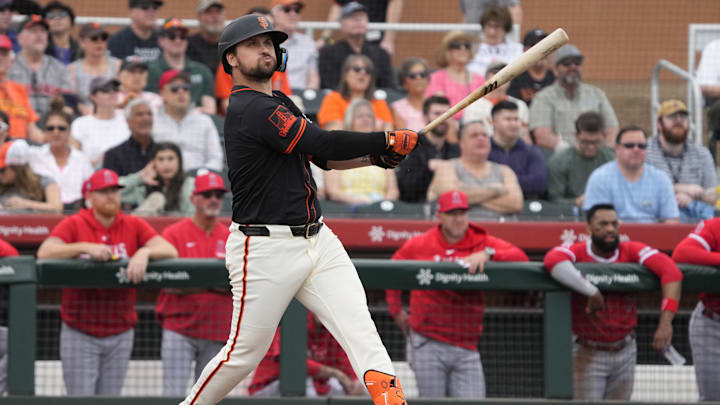 Feb 26, 2024; Scottsdale, Arizona, USA; San Francisco Giants third baseman JD Davis (7) hits against the Los Angeles Angels in the first inning at Scottsdale Stadium. Mandatory Credit: Rick Scuteri-Imagn Images